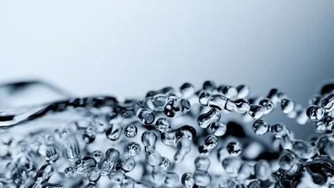 Dynamic Macro Shot of Pure Water Splashing and Curving with Droplets Stock Footage 335508146