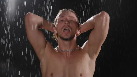 Dynamic male portrait featuring dramatic lighting from a stunning waterfall Stock Footage 313634673