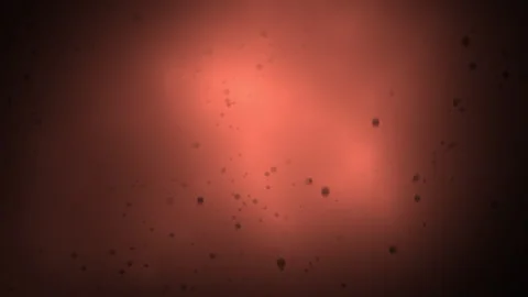 Dynamic motion of black particles in red light Stock Footage 265799888