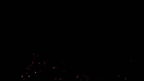 Dynamic motion of glowing red hot embers floating up in dark night Stock Footage 327568841