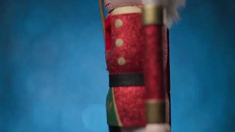 Dynamic motion of the Toy Nutcracker against a lively blue bokeh background, Stock Footage 321679574