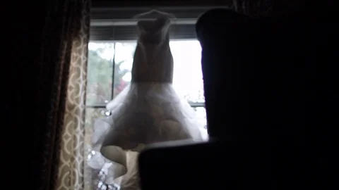 Dynamic move to wedding dress in window rack focus Stock Footage 97093993