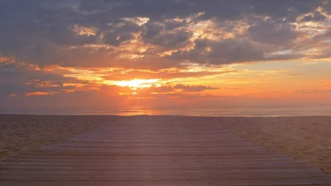 Dynamic movement of the camera along the wooden walkway to the sea Stock Footage 121105609