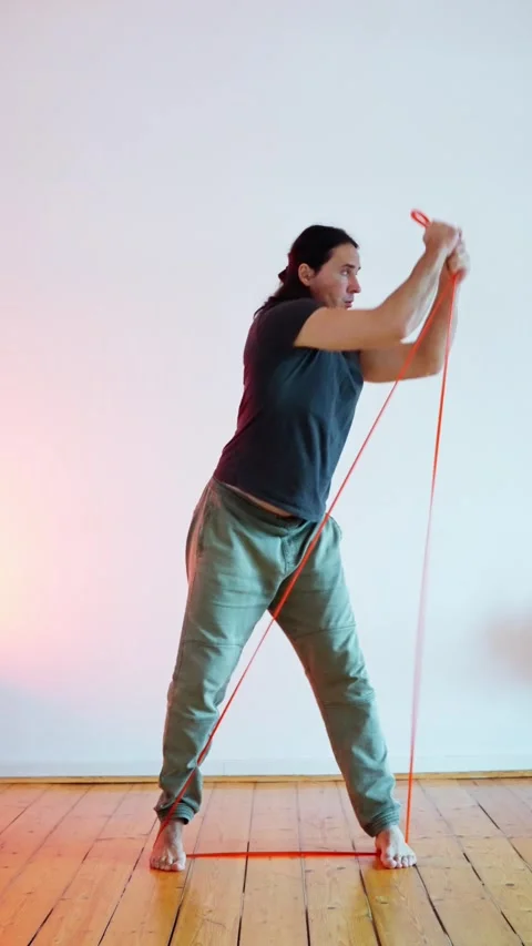 Dynamic Movement with the Use of an Elastic Band in Fitness Training and Stock Footage 302656281