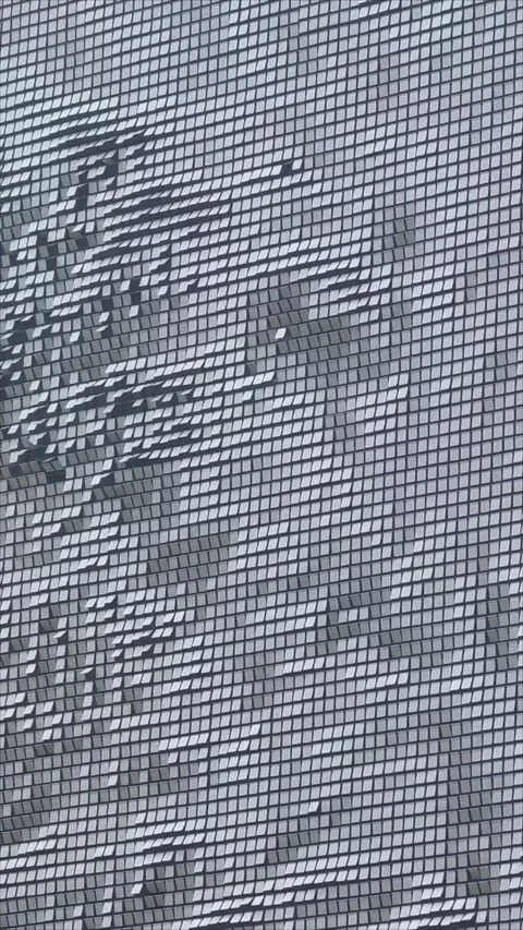 Dynamic moving wind driven wall veil building exterior kinetic metal panel Stock Footage 295938290