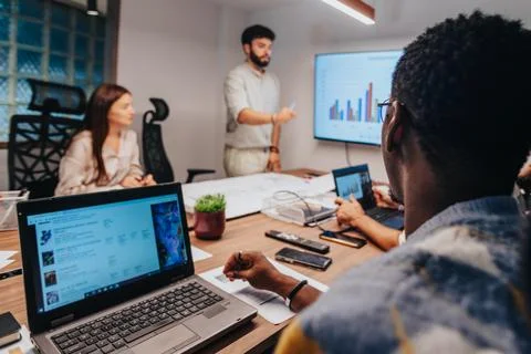 Dynamic Multiracial Team Collaborating on Architectural Project in Board Room Stock Photos