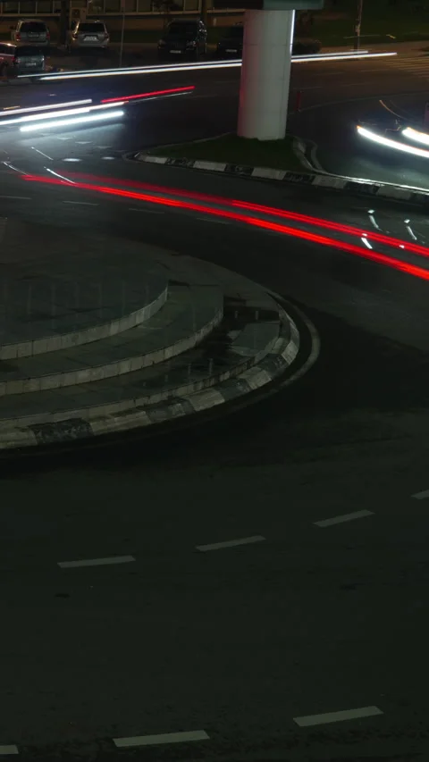 Dynamic night traffic light trails on roundabout. Timelapse of cars fast moving Stock Footage 335852714