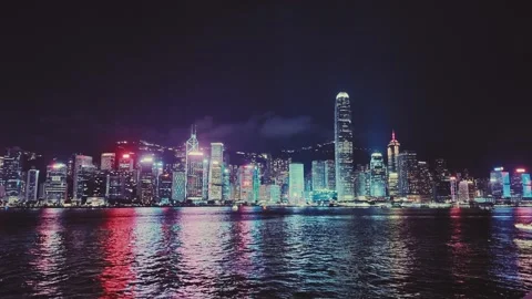 A dynamic night view captures the iconic skyline of Hong Kong's waterfront with Stock Footage 338280490