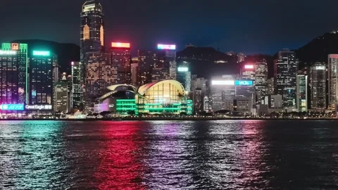 A dynamic night view of Hong Kong's iconic skyline from a waterfront location. Stock Footage 338280352