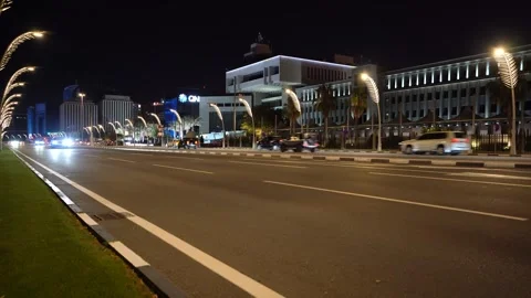 Dynamic nighttime automotive b-roll. A vehicle drives quickly along the Doha Stock Footage 344312914