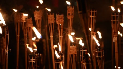 Dynamic nighttime video of multiple bamboo torches burning in Latvia in event 動画素材 321070305