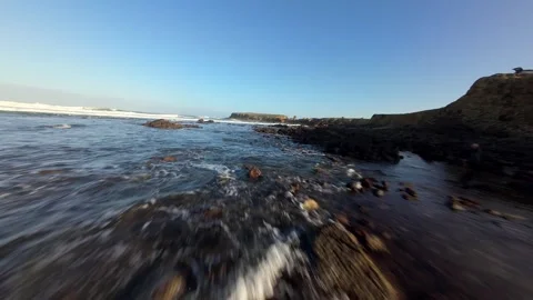 Dynamic ocean footage with crashing waves, rugged shorelines, and sunny skies Video stock 346075845