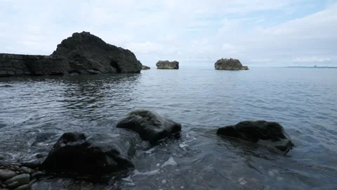 Dynamic ocean tide flowing through rocky coastal crevices in Tsikhisdziri 動画素材 347839234