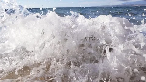 Dynamic ocean wave splashing bright white foam against the coast Stock Footage 337410782