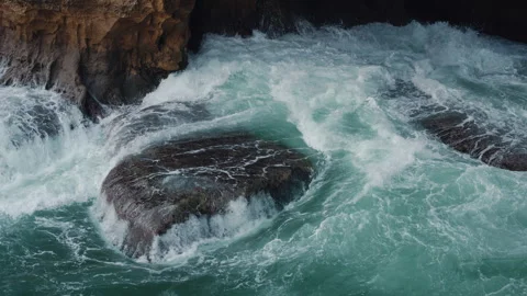 Dynamic Ocean Waves Aggressively Crashing Against the Rugged Rocky Shoreline Stock Footage 302842888