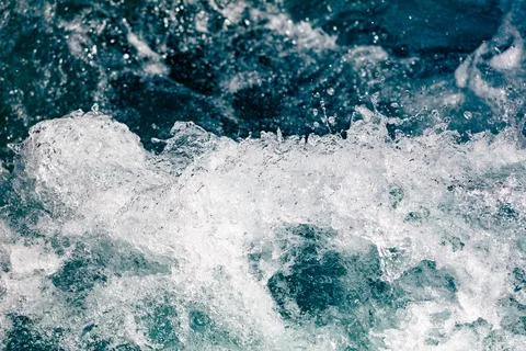 Dynamic ocean waves crash with white foam and deep blue water Stock Photos