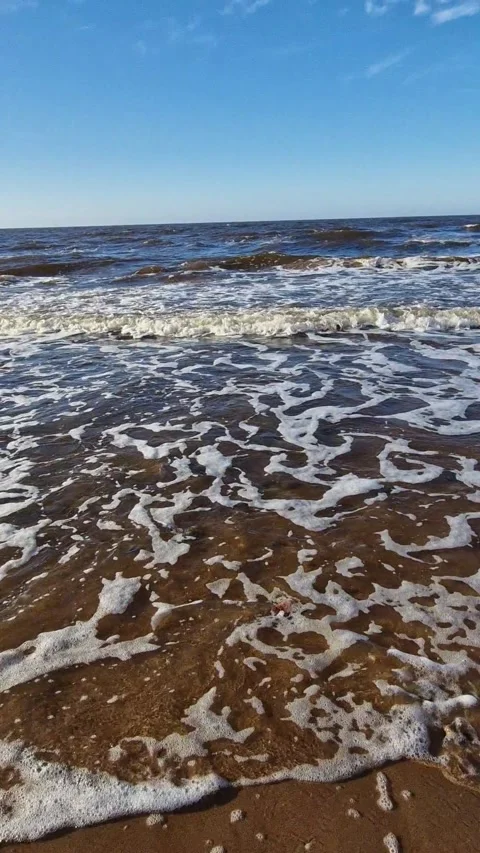 Dynamic Ocean Waves Crashing on Sandy Beach Stock Footage 299719334