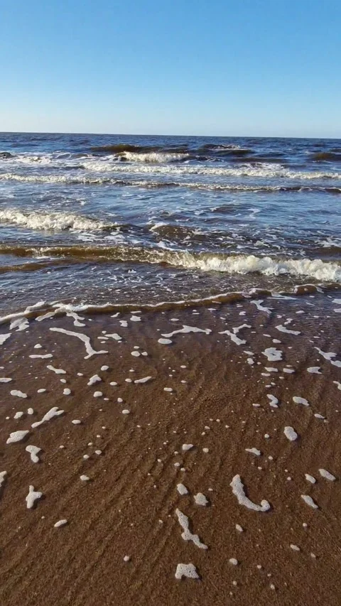 Dynamic Ocean Waves Crashing on Sandy Beach Stock Footage 299719589