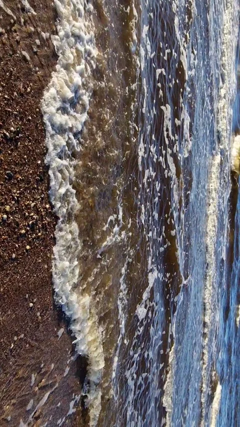 Dynamic Ocean Waves Crashing on Sandy Beach Stock Footage 299719739
