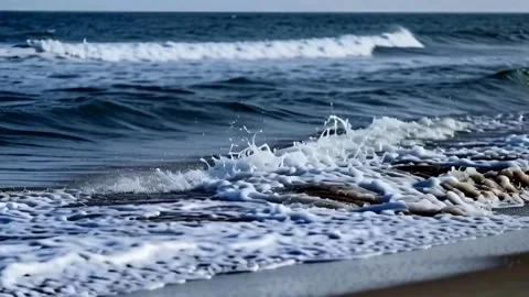 Dynamic Ocean Waves Crashing on Sandy Beach with Foamy Splashes a Captivati.. Stock Footage 321948524