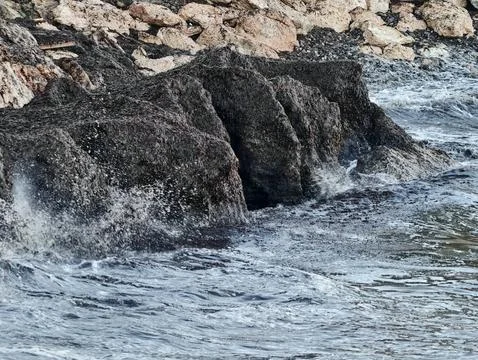 Dynamic ocean waves gradually sculpt resilient rocky coastlines amid ongoin.. Фото