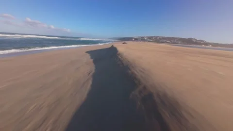 Dynamic ocean waves meet golden sand under sunny sky Stock Footage 344581463
