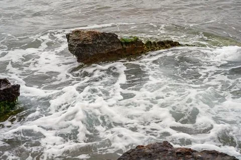 Dynamic ocean waves on rugged shore Stock Photos