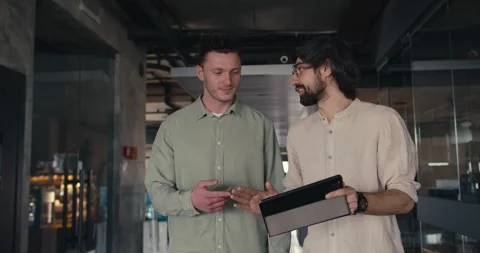Dynamic Office Collaboration: Brunette Guys in Green and Pink Shirts, Handshake Stock Footage 242899300