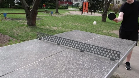 Dynamic outdoor table tennis match in a sunny park. Players actively hitting Vidéo 328420524