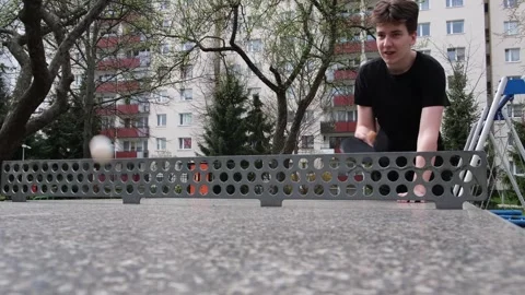 Dynamic outdoor table tennis match in a sunny park. Players actively hitting Vidéo 328420908