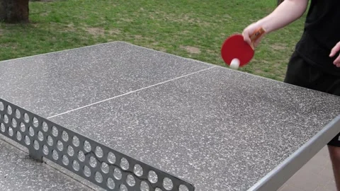 Dynamic outdoor table tennis match in a sunny park. Players actively hitting Stock Footage 328420948