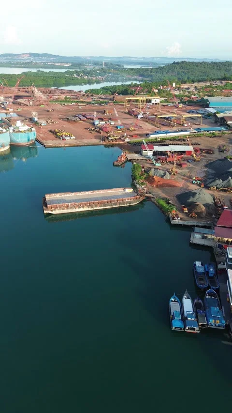 Dynamic overhead view showcases a vibrant coastal industrial port, bustling.. Video stock 337282722