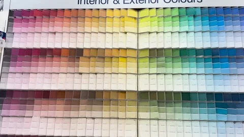 Dynamic pan across vast wall of colorful paint swatches in various shades. Stock Footage 333840198