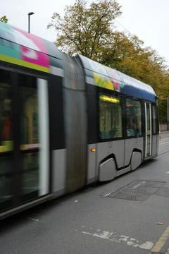 Dynamic Panning Shot Of Modern Light Rail Tram In Motion In Nottingham, England. Stock Photos