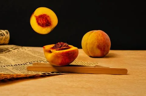 Dynamic peach composition on the desk with old newsletter paper Stock Photos