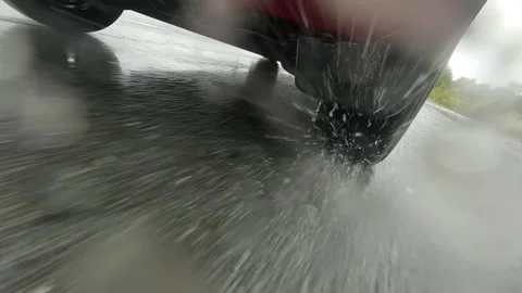 A Dynamic Perspective of a Car in Motion on a Rainy Day: Capturing the Thrill Video stock 342832204