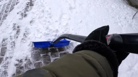 Dynamic POV from shoulder height as a gloved hand drives a blue shovel into a Stock Footage 331657499