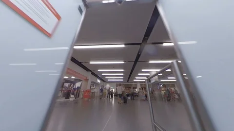 Dynamic POV as traveller walks through airport arrivals automatic door v2 Stock Footage 118253495