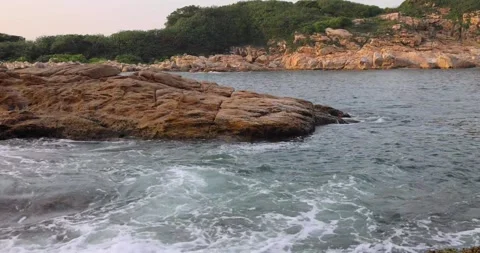 Dynamic powerful ocean or sea wave or wave setup hits on granite rock coast c Stock Footage 155225002