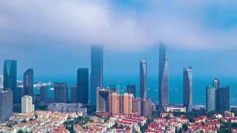 Dynamic Qingdao Cityscape: Clouds Clearing Over Coastal Skyline Stock Footage 330882439