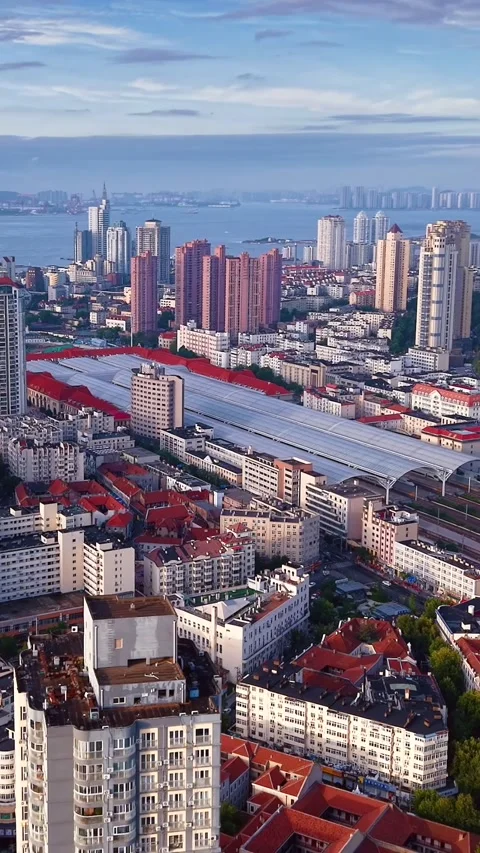 Dynamic Qingdao: High-Speed Rail Station Amidst Bustling City Stock Footage 330729156