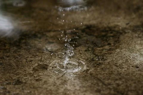 Dynamic Rain Water Splash on Rough Concrete Floor Texture Background, High .. Stock Photos