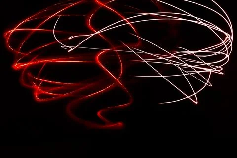 Dynamic red and white light painting trails creating abstract motion agains.. Stock Photos