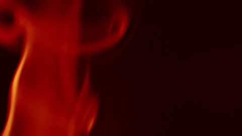 Dynamic red smoke shapes move gracefully against a solid black background, ideal Stock Footage 315339610