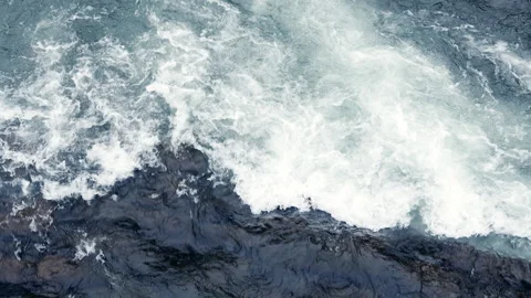Dynamic River Estuary Closeup with Flowing Waves and Rocks. Video stock 332152695