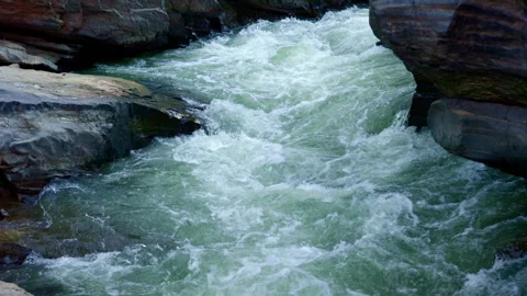 Dynamic River Flow: Captivating Views of Rushing Waters and Rocky Edges Stock Footage 314197415
