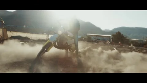 Dynamic Off-Road Motorcycle Action in Dusty Terrain Stock Footage 323300302