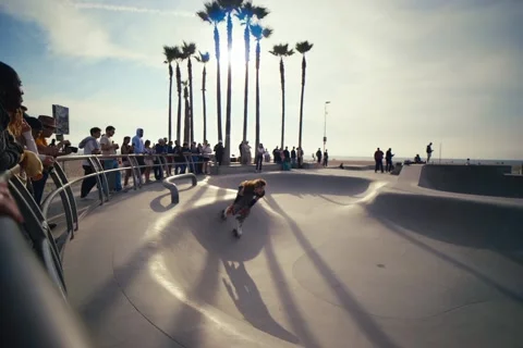 Dynamic Roller Skater Performing Stylish Tricks at Venice Beach Skate Park Stock Footage 322135993