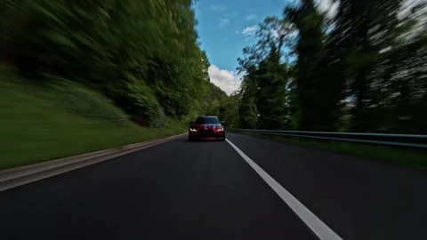 Dynamic rolling shot of  BMW M3 sports cars convoy driving on a winding mountain 動画素材 328647827