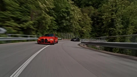 Dynamic rollings hot of BMW M3 sports cars convoy speeding along mountain road Stock Footage 328647750